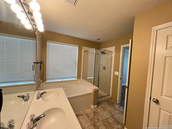 a bathroom with a tub sink and a mirror