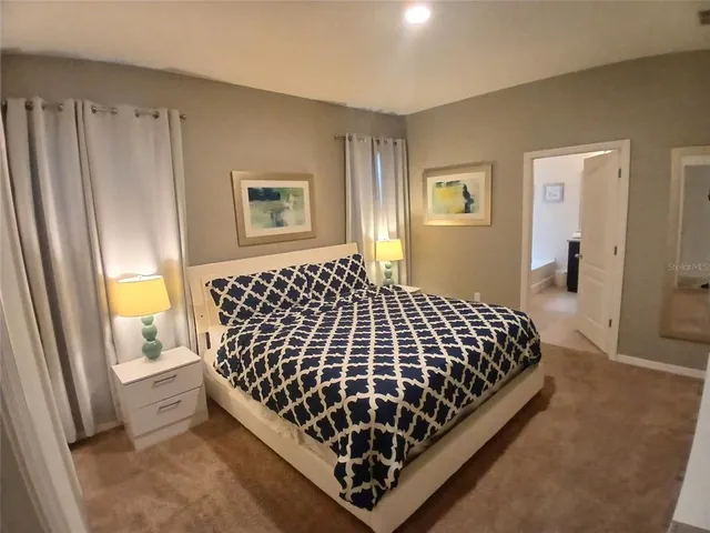 a kitchen with granite countertop a sink a stove a microwave a counter top space and cabinets