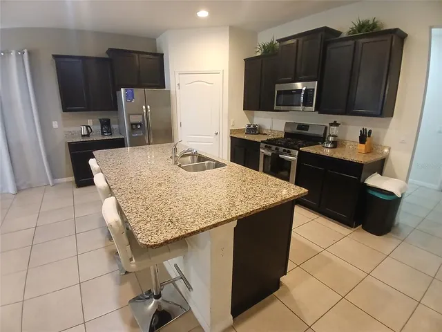 a bedroom with a bed and painting on the wall