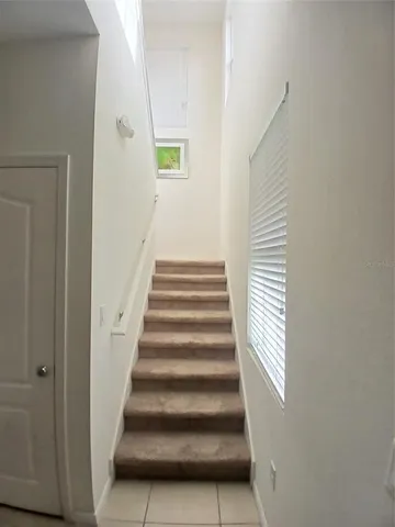a bedroom with a bed and a flat tv screen on dresser