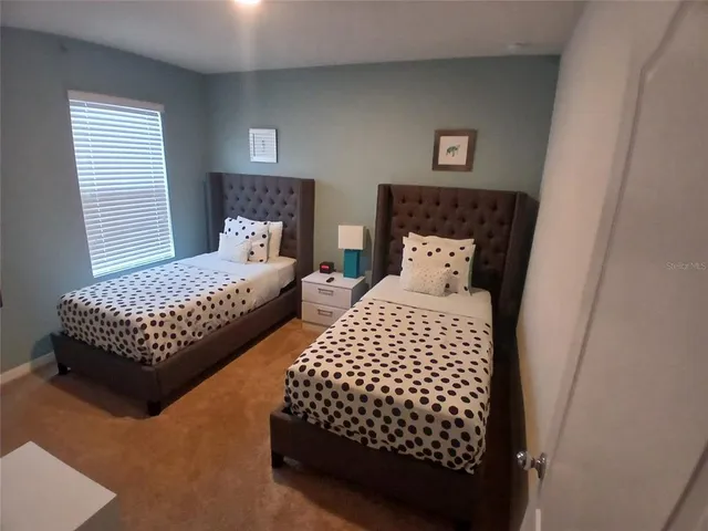 a front view of a house with garden and plants