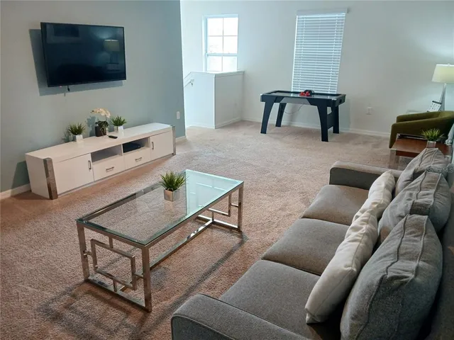 a patio with a table and chairs under an umbrella