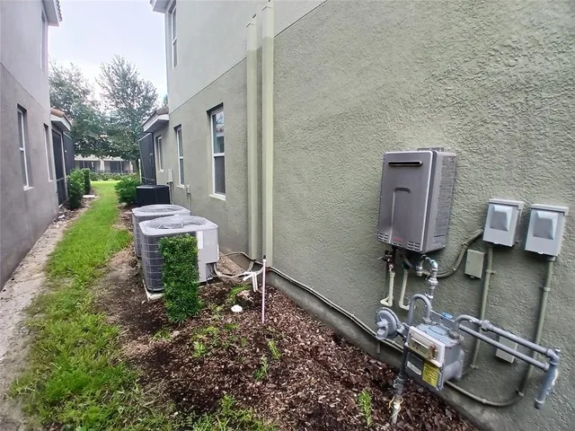 a front view of a house with a garden and palm trees