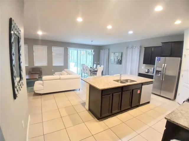 a kitchen with stainless steel appliances a stove refrigerator sink and microwave