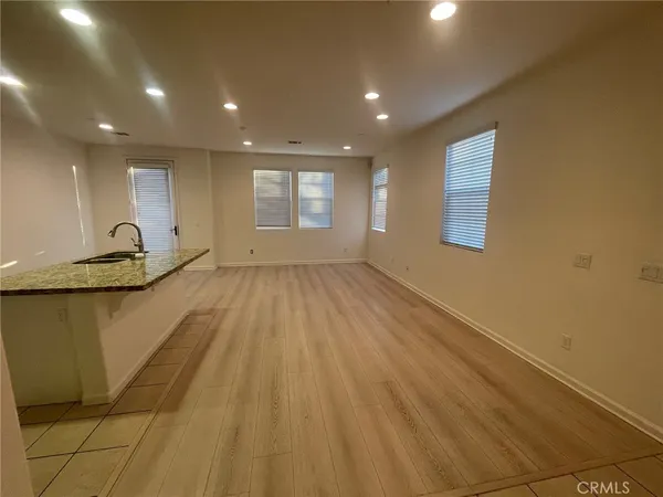 a view of a livingroom with wooden floor and a window