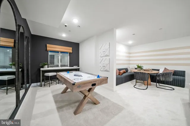 a room with table chairs and windows