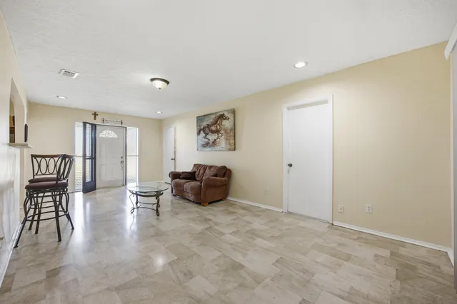a spacious bedroom with a bed and furniture