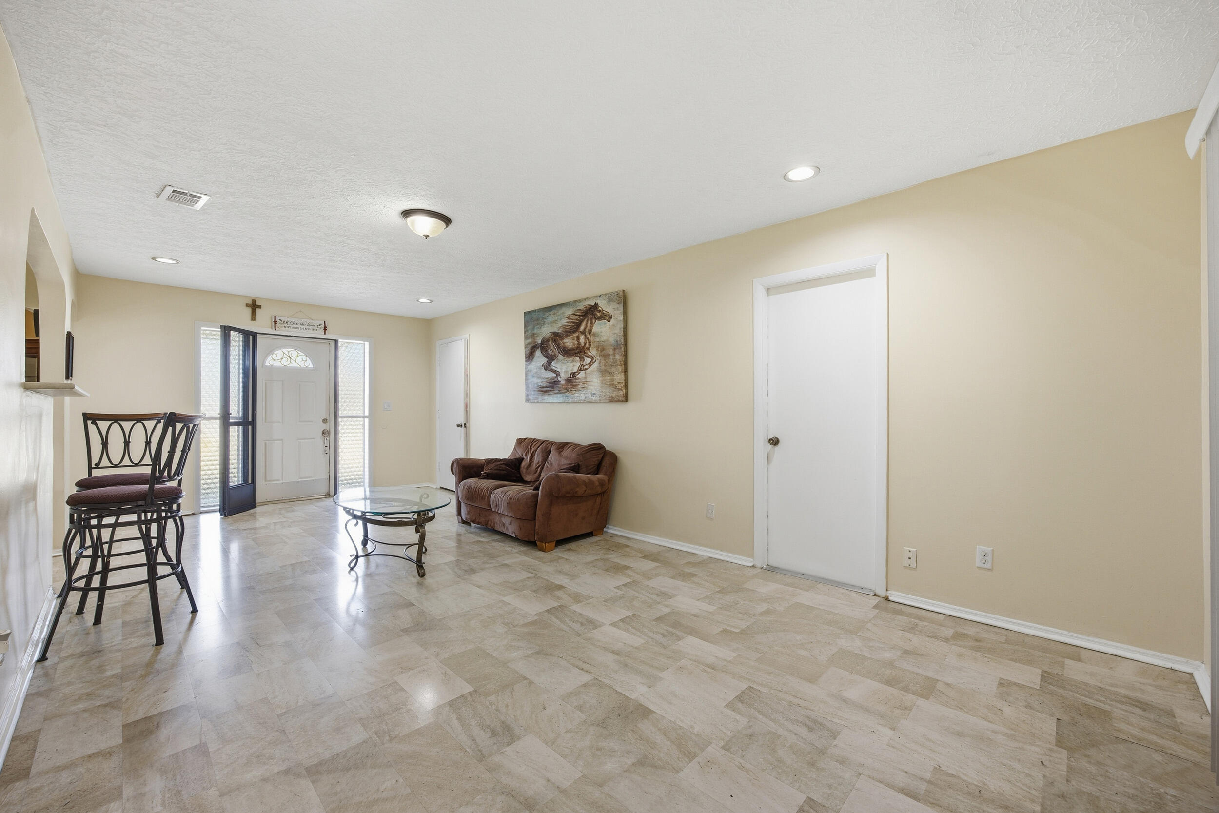 1102 Southeast Petunia Avenue Port St. Lucie, FL 34952 - Photo 5 of 23 a spacious bedroom with a bed and furniture