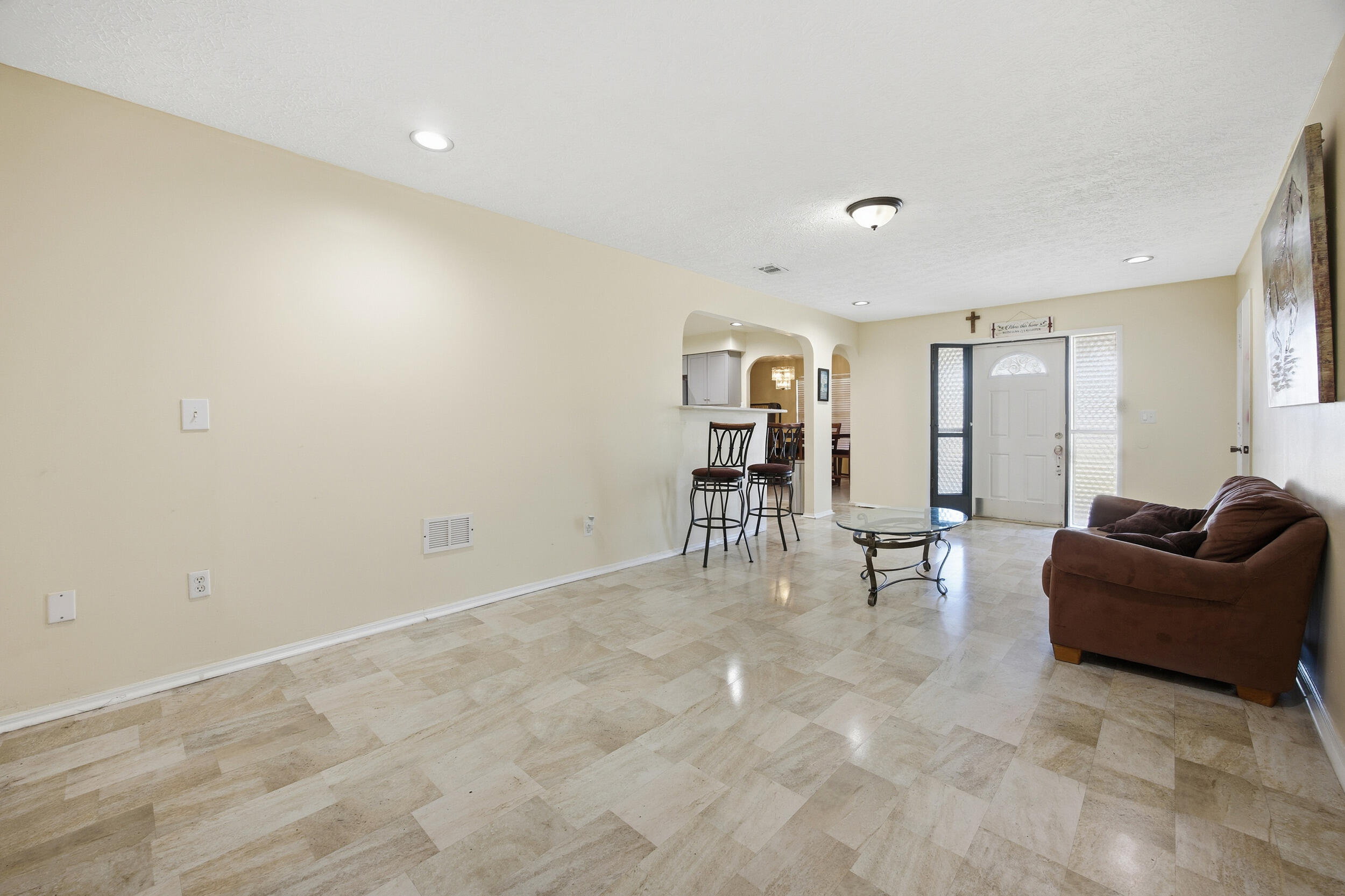 1102 Southeast Petunia Avenue Port St. Lucie, FL 34952 - Photo 6 of 23 a living room with furniture and a table