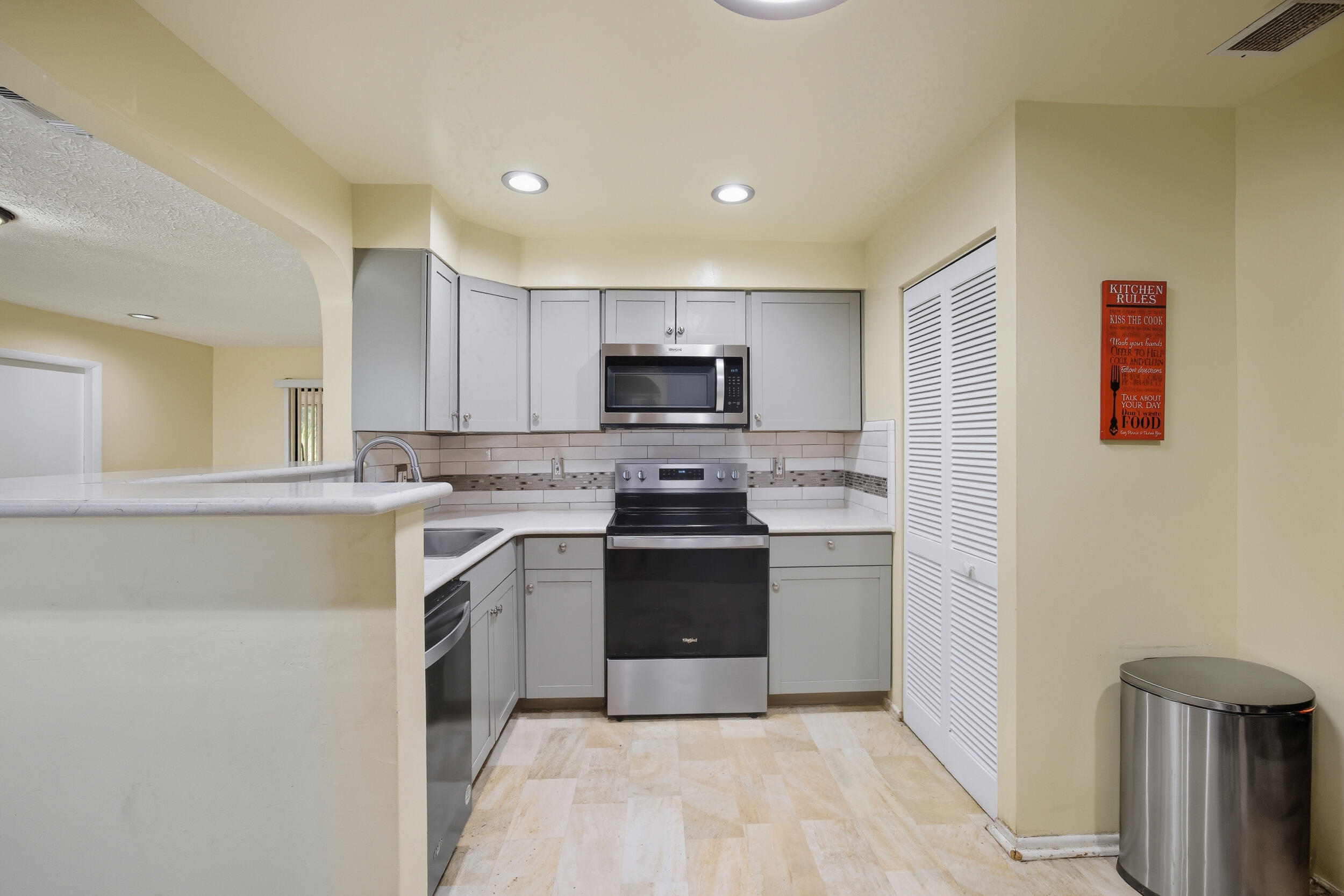 1102 Southeast Petunia Avenue Port St. Lucie, FL 34952 - Photo 7 of 23 a kitchen with a stove and a microwave