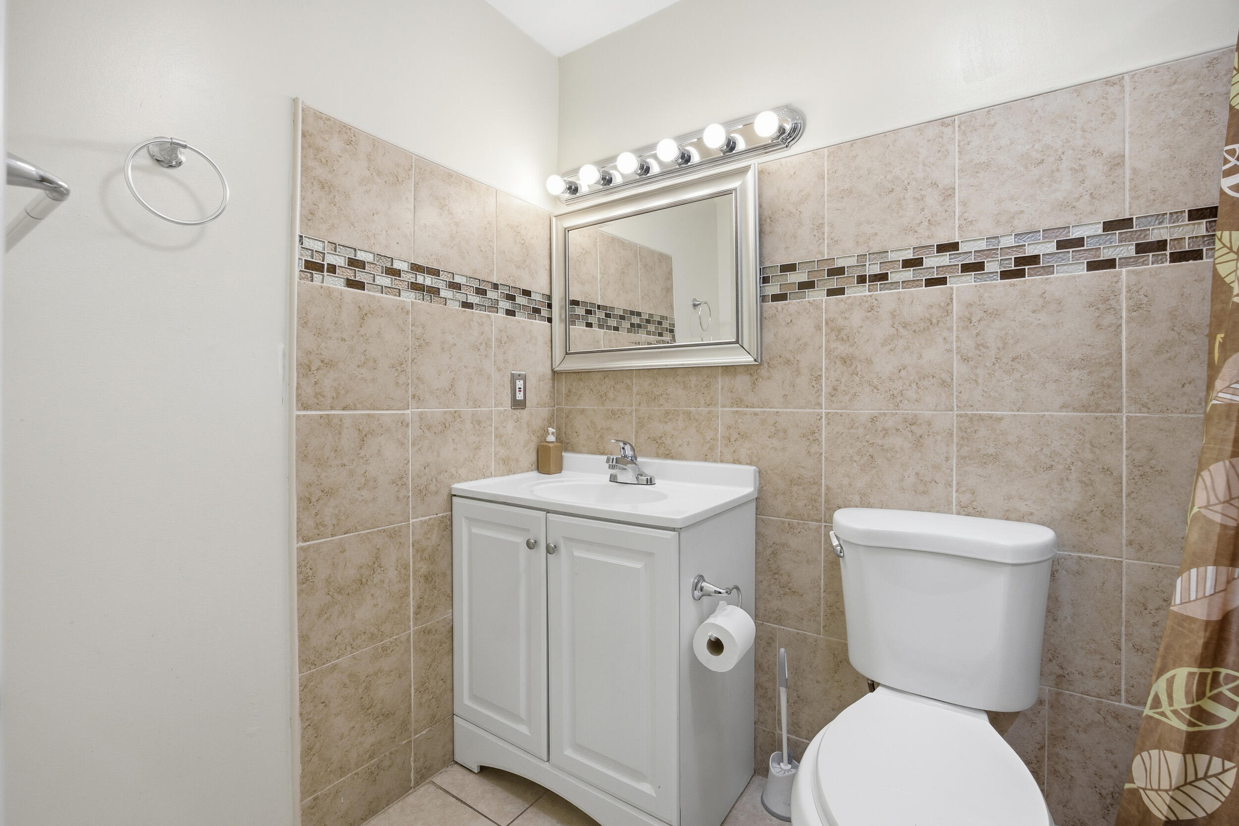1102 Southeast Petunia Avenue Port St. Lucie, FL 34952 - Photo 10 of 23 a bathroom with a toilet sink and shower