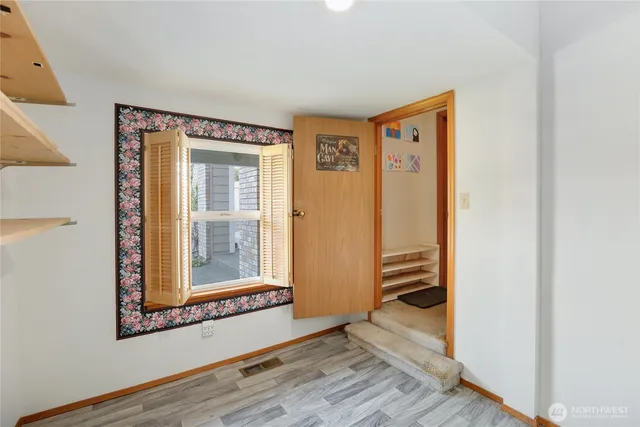 a view of walk in closet with empty racks