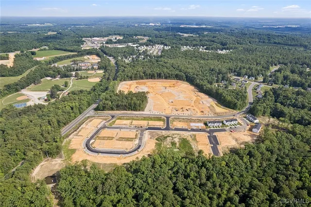 an aerial view of residential houses with outdoor space and river