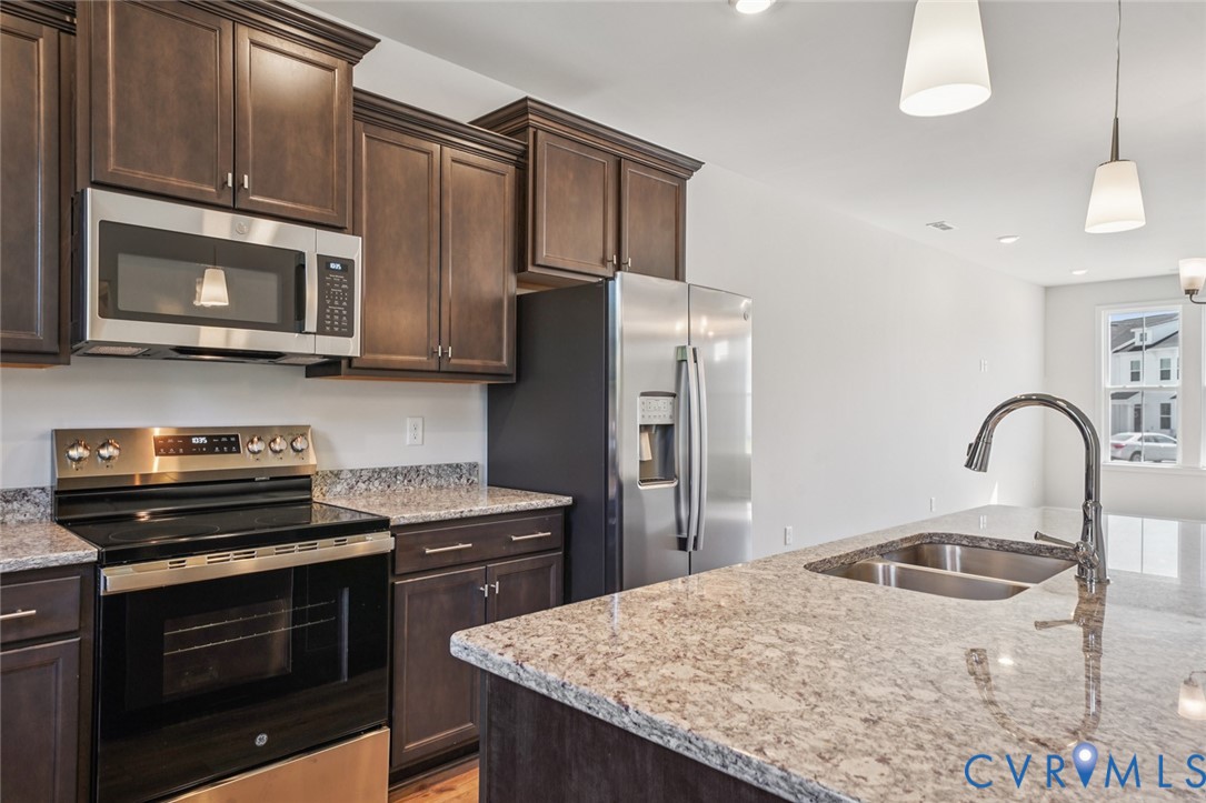 342 Mt Mccauley Way Aylett, VA 23009 - Photo 3 of 31 a kitchen with stainless steel appliances granite countertop a stove microwave and refrigerator