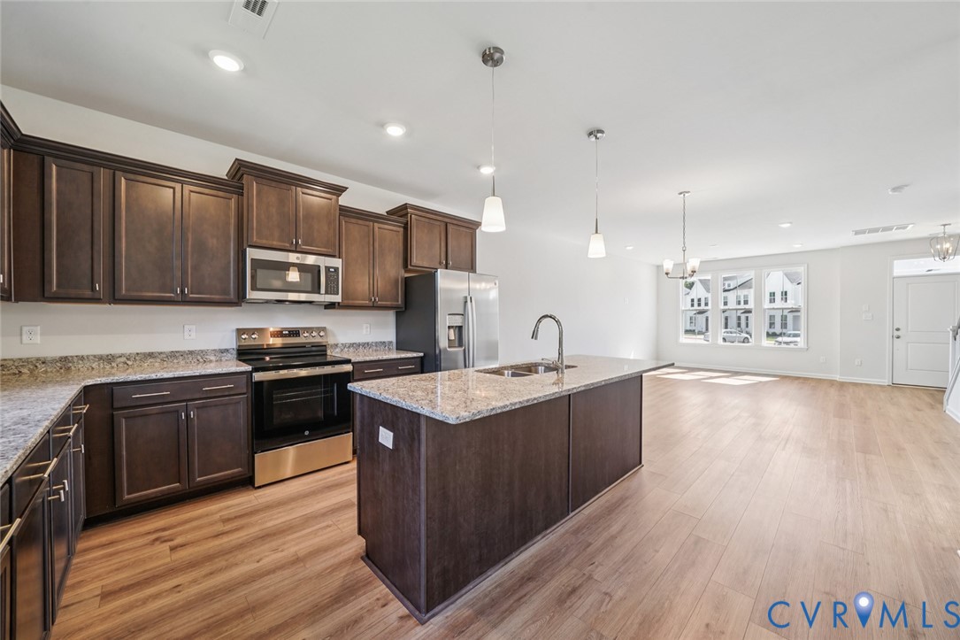 342 Mt Mccauley Way Aylett, VA 23009 - Photo 5 of 31 a kitchen with stainless steel appliances granite countertop a sink stove and refrigerator