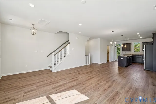 a view of kitchen and hall with wooden floor