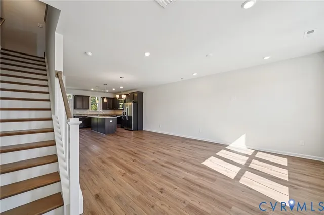 a view of a living room with furniture and wooden floor