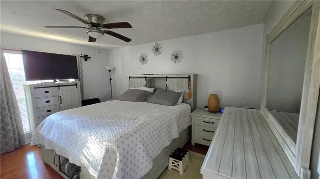 a bed room with a bed and a flat tv screen on dresser