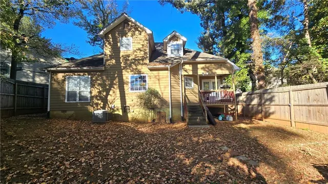 a view of a house with a yard and sitting area
