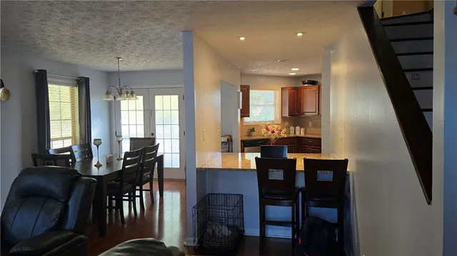 a view of a a dining room with furniture window and wooden floor