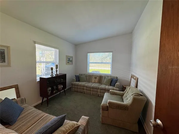a living room with furniture window and a wooden floor