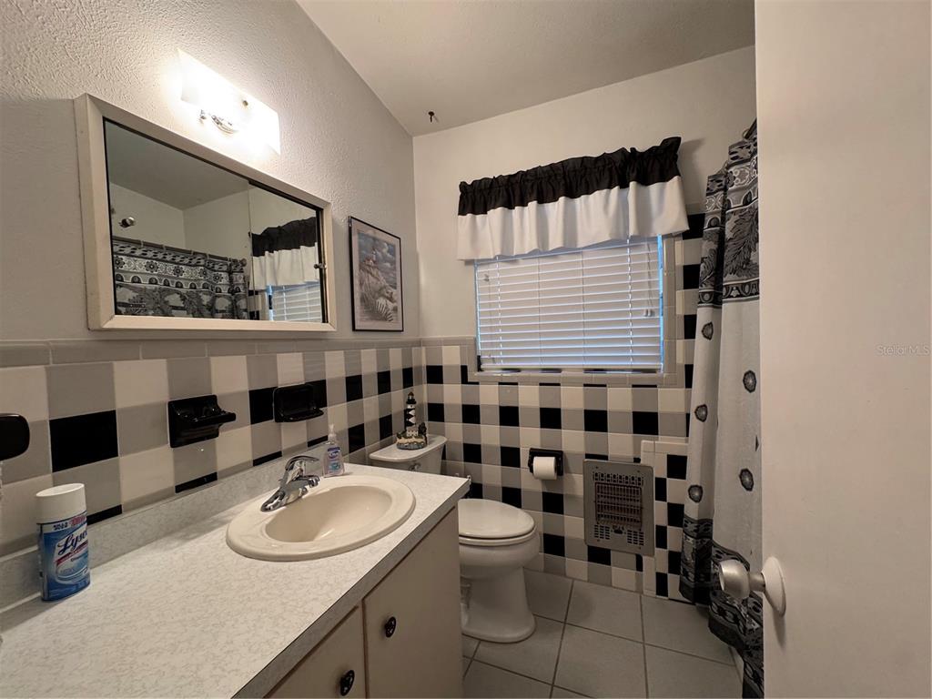 2263 North Lake Reedy Boulevard Frostproof, FL 33843 - Photo 22 of 50 a bathroom with a sink toilet and shower