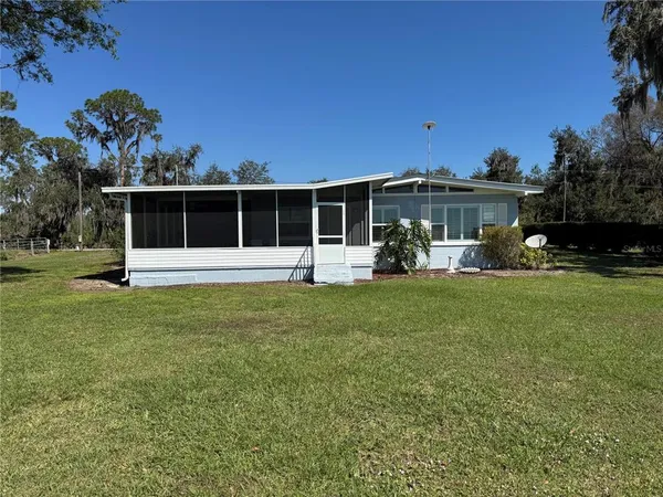 a view of a house with backyard and porch