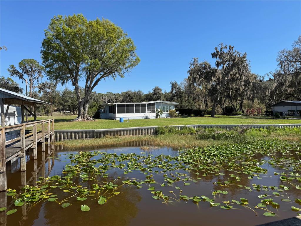 2263 North Lake Reedy Boulevard Frostproof, FL 33843 - Photo 33 of 49 a view of building with garden and trees in the background