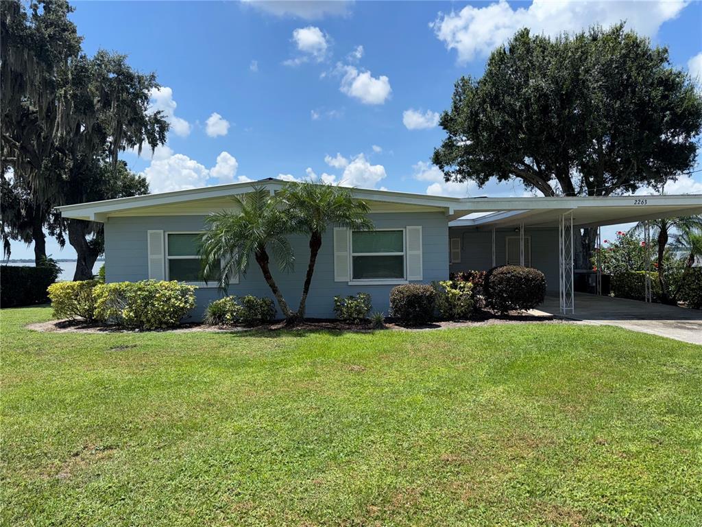 2263 North Lake Reedy Boulevard Frostproof, FL 33843 - Photo 44 of 50 a view of a house with backyard and garden