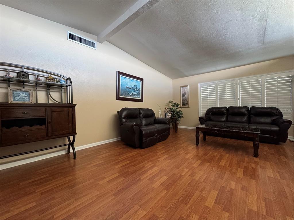 2263 North Lake Reedy Boulevard Frostproof, FL 33843 - Photo 5 of 50 a living room with furniture a ceiling fan and a window