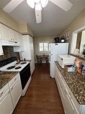 a large kitchen with a stove and a refrigerator