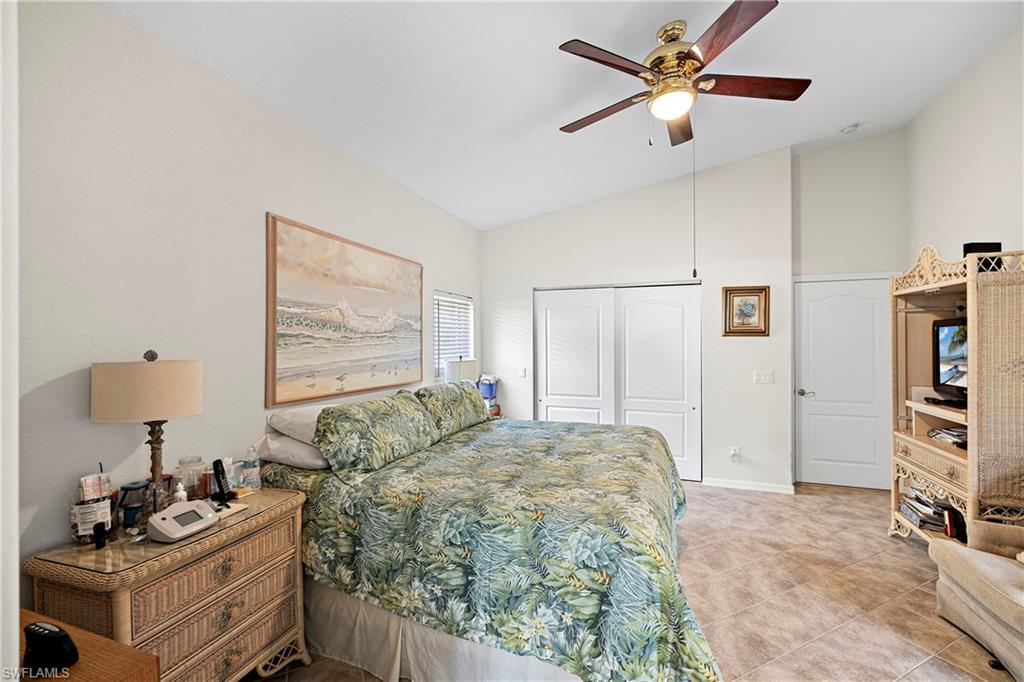 227 Glen Eagle Circle Naples, FL 34104 - Photo 14 of 25 a bed room with a bed and a window