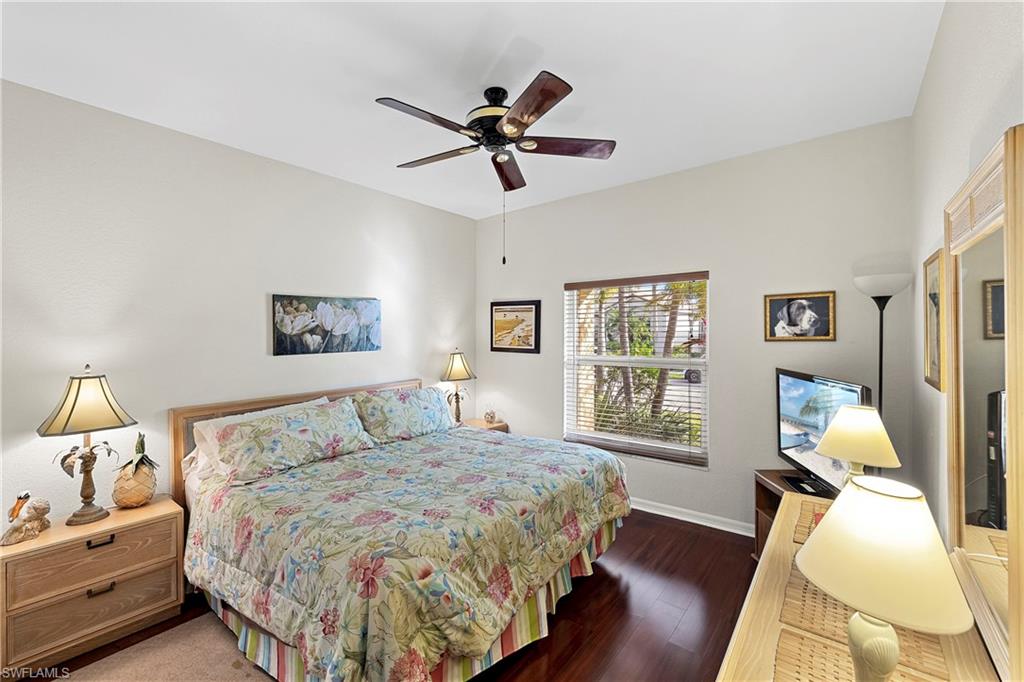 227 Glen Eagle Circle Naples, FL 34104 - Photo 19 of 25 a bedroom with a bed and wooden floor