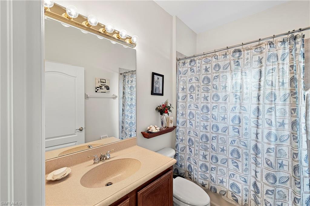 227 Glen Eagle Circle Naples, FL 34104 - Photo 21 of 25 a bathroom with a sink toilet and shower