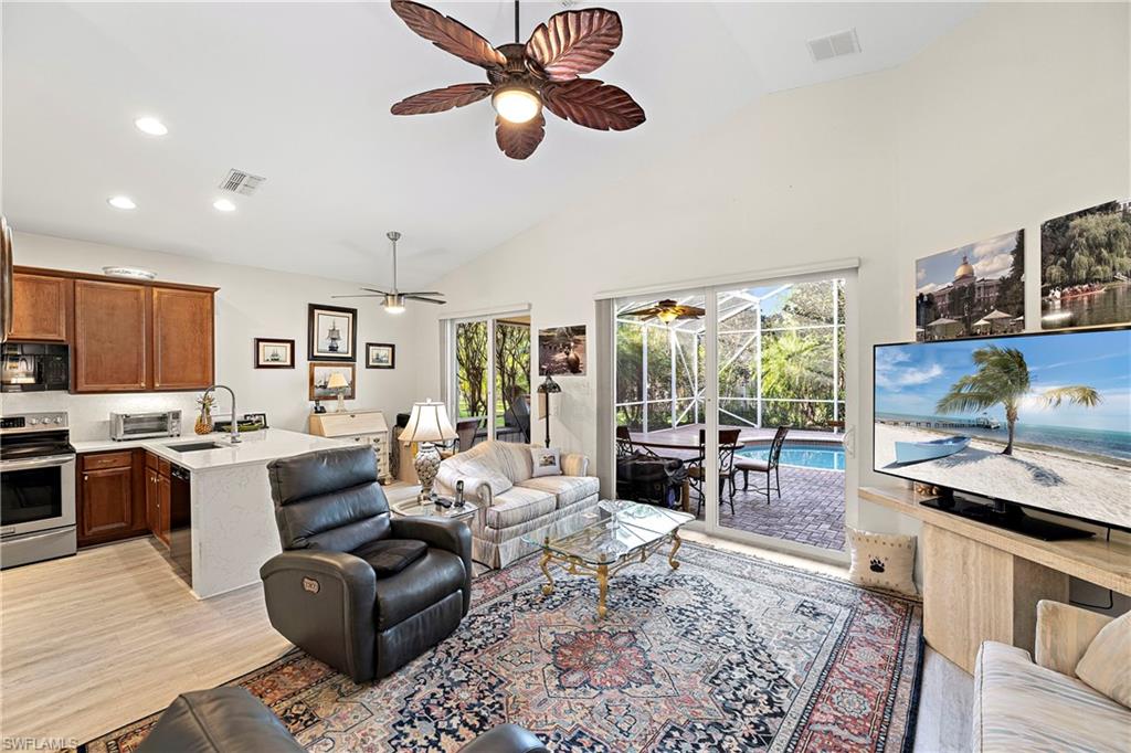227 Glen Eagle Circle Naples, FL 34104 - Photo 9 of 25 a living room with furniture and a large window