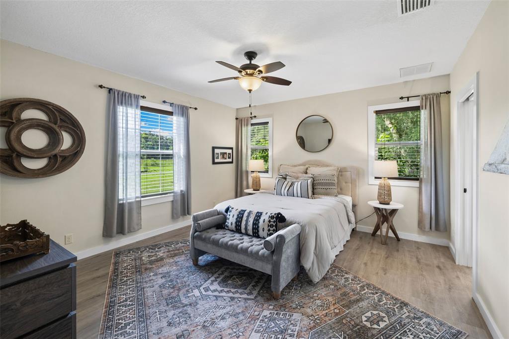 14765 Highway 41 Spring Hill, FL 34610 - Photo 13 of 61 a bedroom with a bed and a chandelier