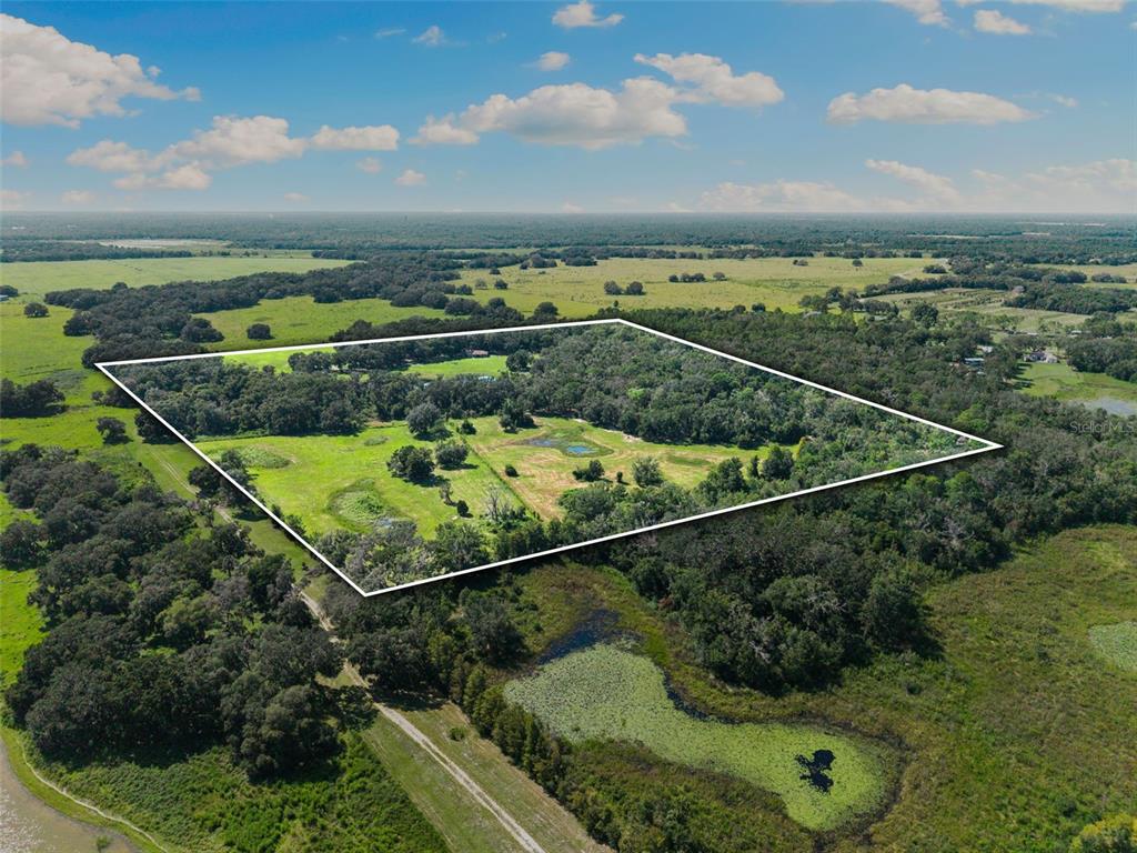 14765 Highway 41 Spring Hill, FL 34610 - Photo 26 of 61 an aerial view of a residential houses with outdoor space and trees