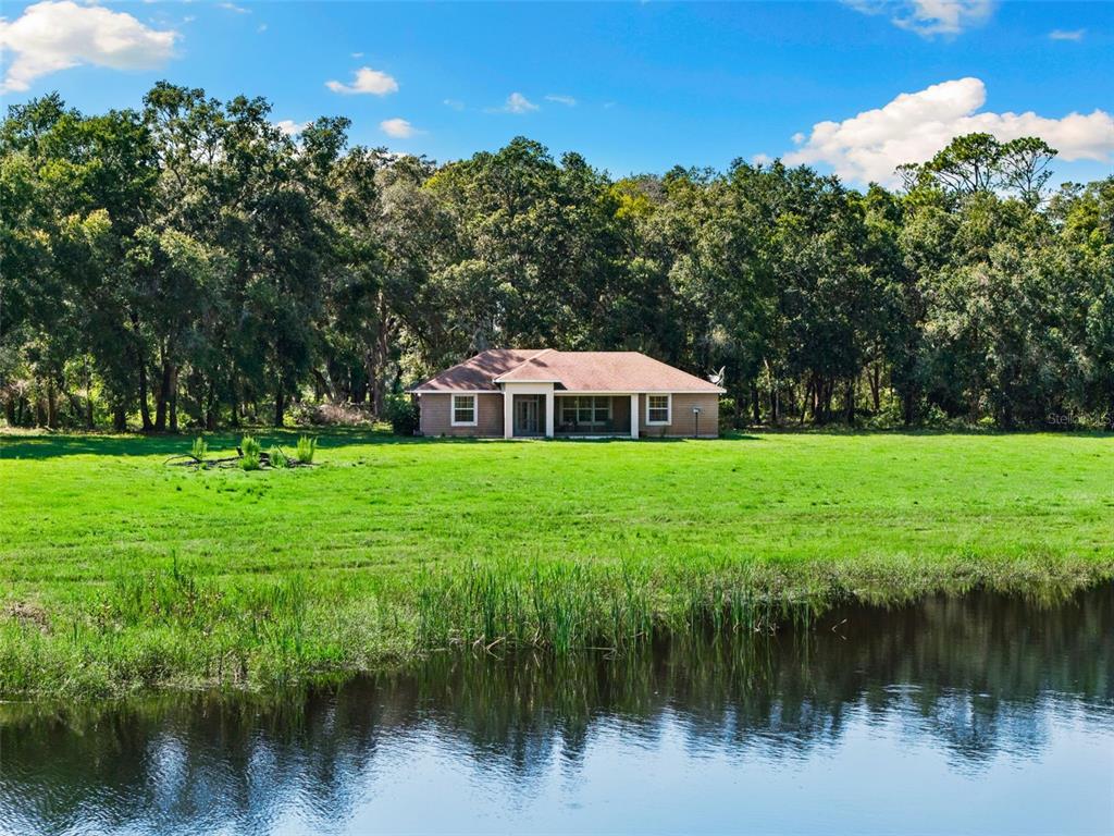 14765 Highway 41 Spring Hill, FL 34610 - Photo 37 of 61 a swimming pool with a lake view