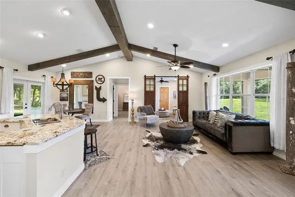 a view of a hallway with entryway wooden floor and a chandelier