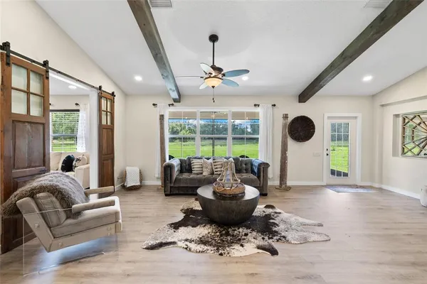 a living room with furniture and a large window