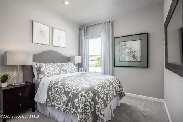 a bedroom with a bed and a painting on the wall