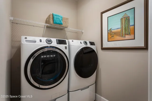 a view of a hallway with washer and dryer