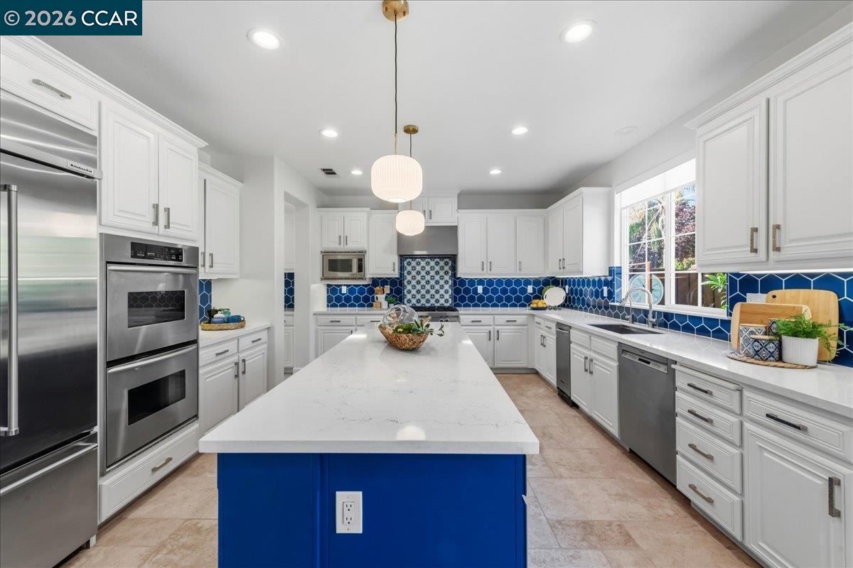 211 Cullens Court San Ramon, CA 94582 - Photo 13 of 56 a kitchen with white cabinets and stainless steel appliances