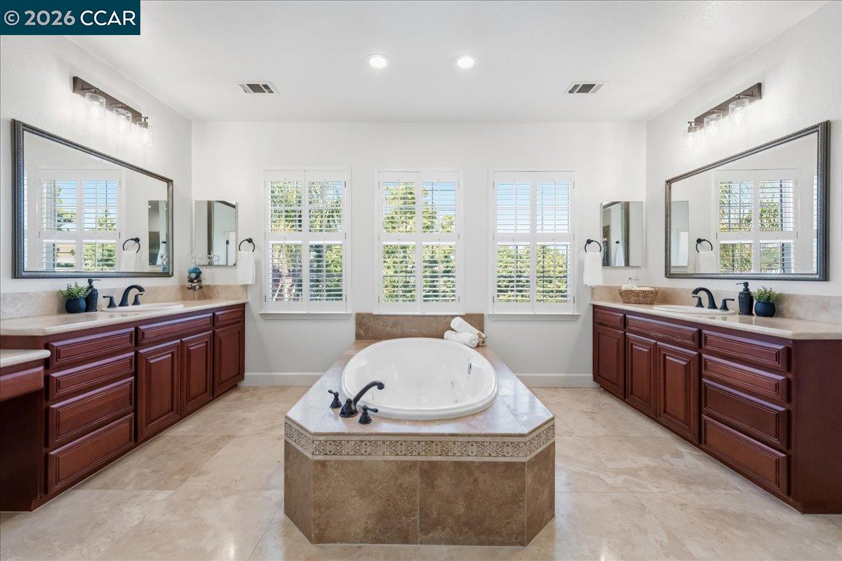211 Cullens Court San Ramon, CA 94582 - Photo 26 of 56 a spacious bathroom with a tub sink and mirror