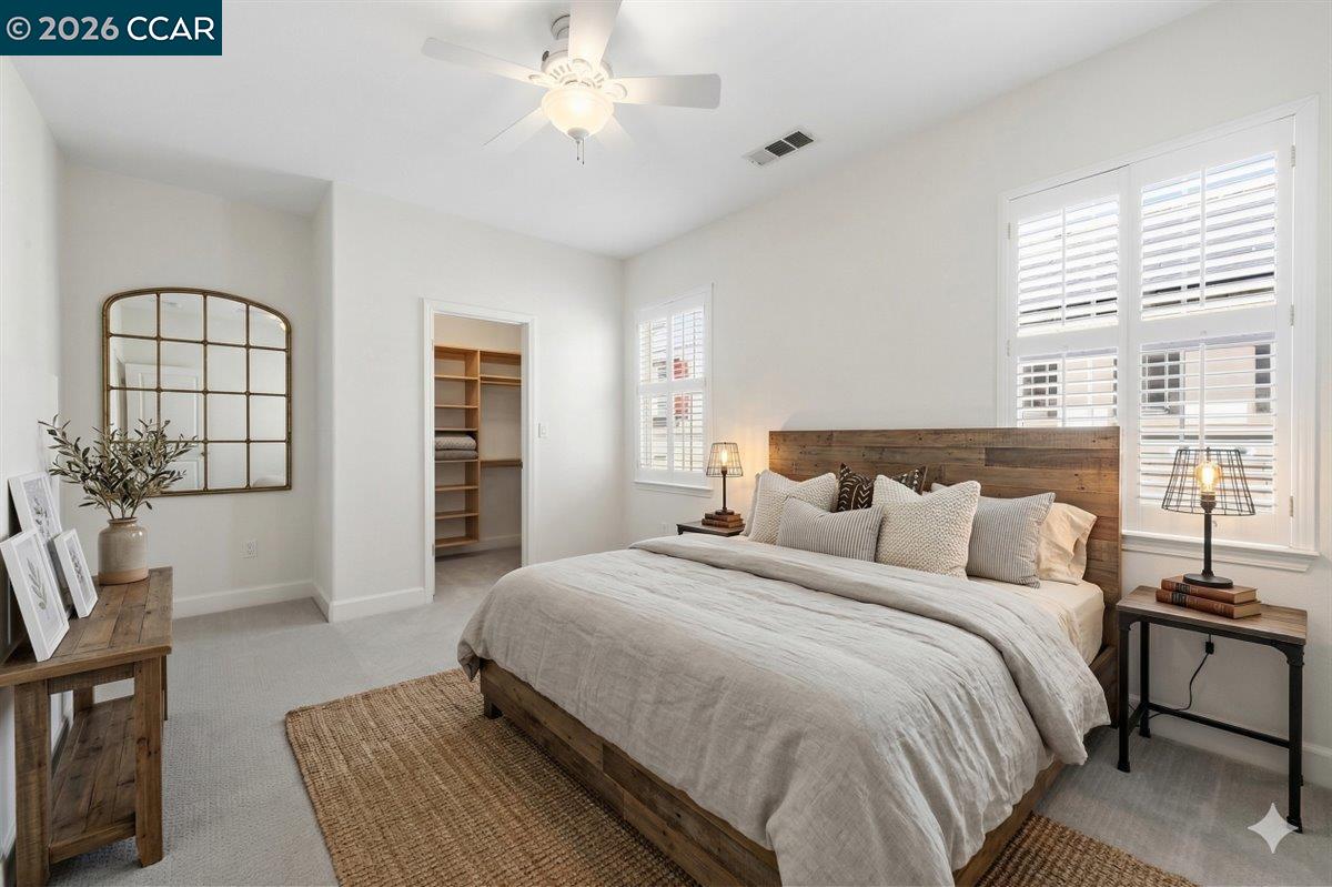 211 Cullens Court San Ramon, CA 94582 - Photo 31 of 56 a spacious bedroom with a bed a couch and a potted plant on the dresser