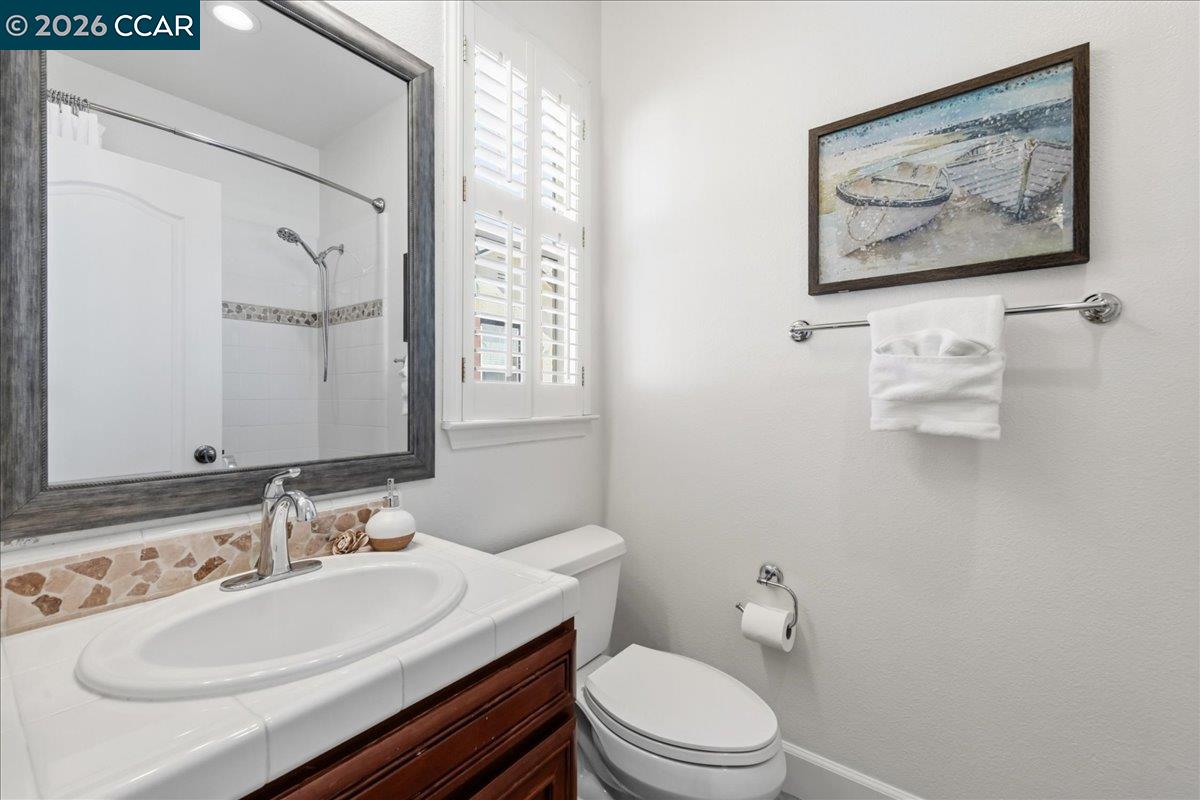 211 Cullens Court San Ramon, CA 94582 - Photo 35 of 56 a bathroom with a toilet a sink and mirror
