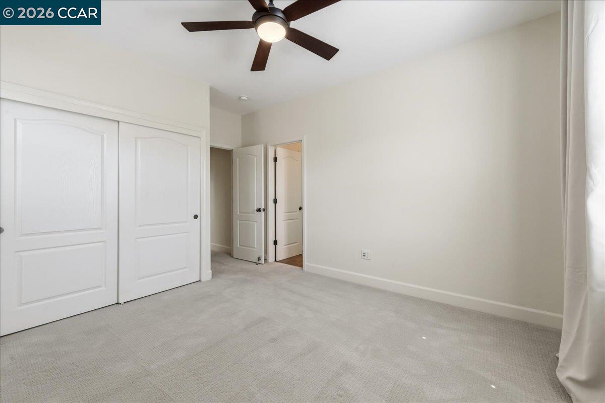 211 Cullens Court San Ramon, CA 94582 - Photo 37 of 56 an empty room with closet and a chandelier fan