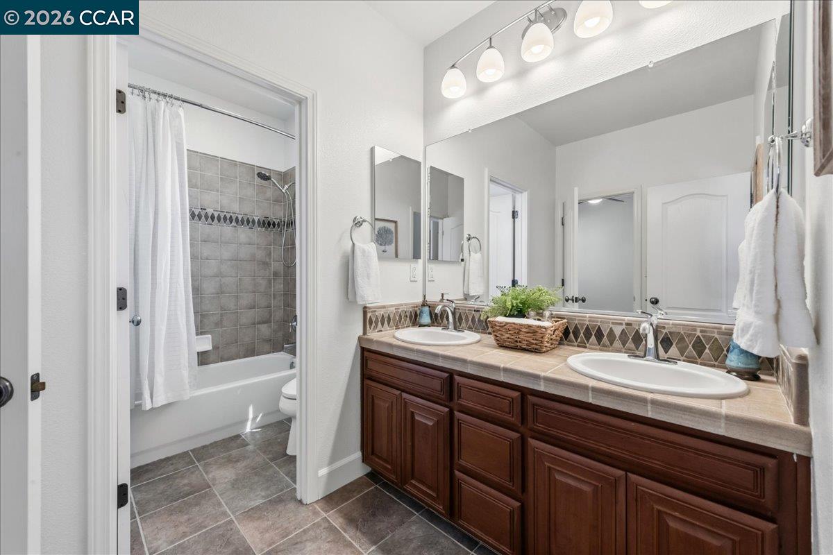 211 Cullens Court San Ramon, CA 94582 - Photo 39 of 56 a bathroom with a double vanity sink mirror double shower and a bathtub