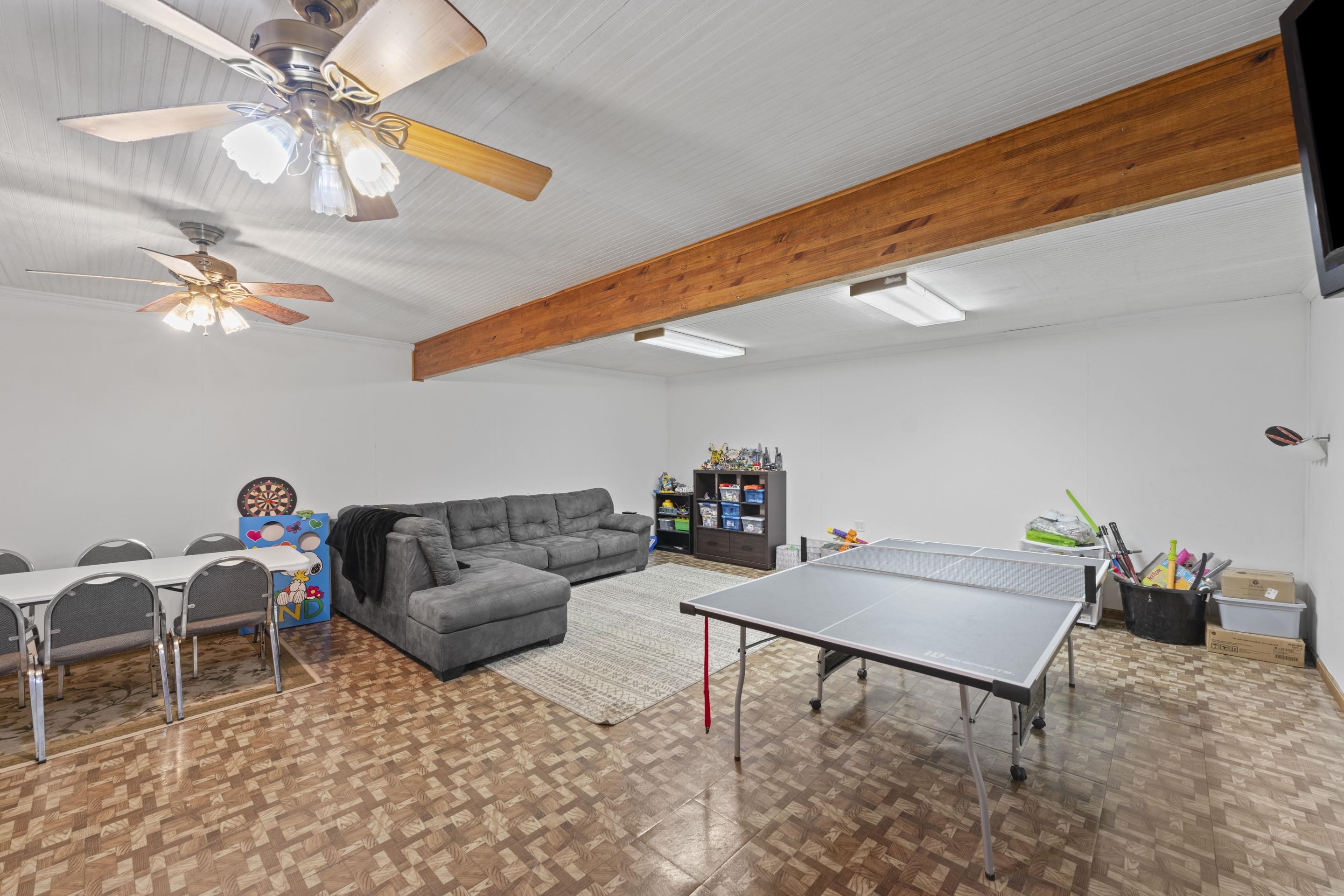 a living room with furniture and a chandelier
