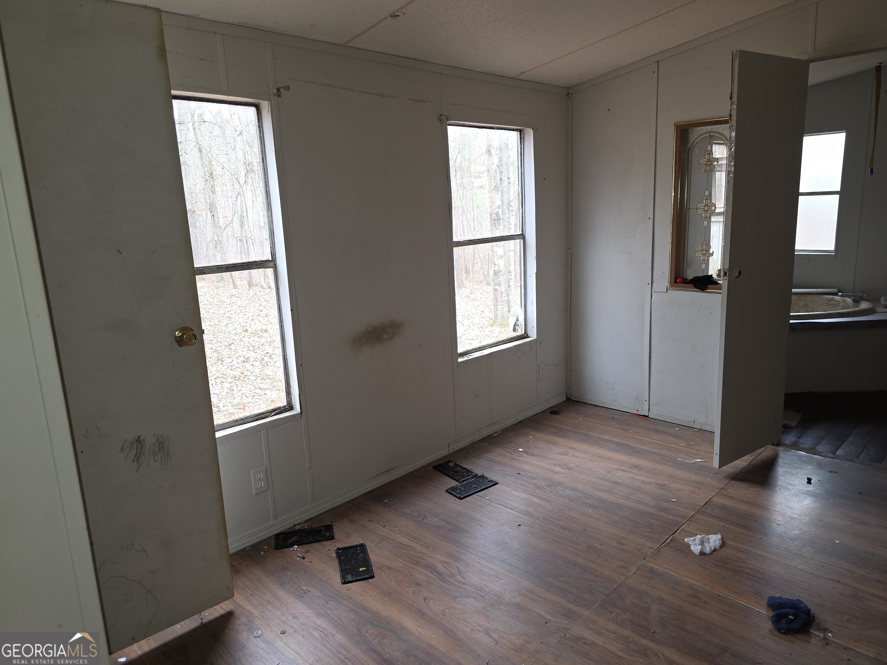 650 Wildcat Road Buchanan, GA 30113 - Photo 14 of 26 an empty room with wooden floor and windows